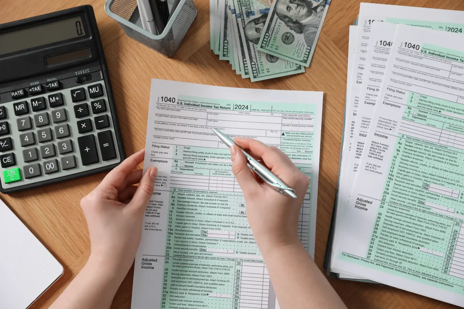 payroll-woman-working-with-tax-return-forms-at-wo-7G2LBMX.webp